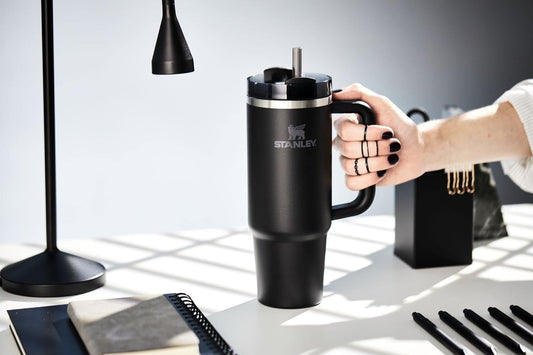 UrbanBaazar 40 oz Stanley tumbler with stainless steel body and black lid, designed for hot and cold beverages.