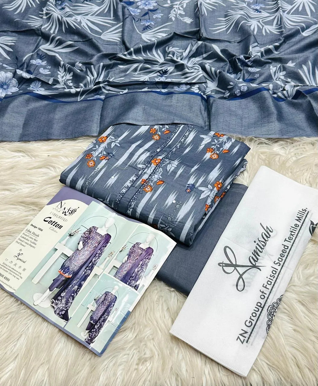 Three pieces of UrbanBaazar women's unstitched embroidered suit displayed together, showcasing intricate designs and fabric.