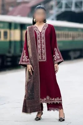 Three pieces of UrbanBaazar women's unstitched embroidered suit with intricate designs and vibrant colors on display.