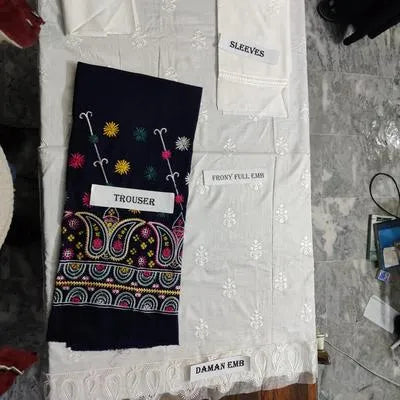 Two pieces of women's unstitched embroidered suit by UrbanBaazar featuring intricate designs and vibrant colors.